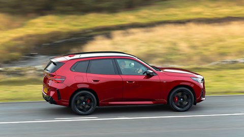 BMW X3 (2024) review: side rear driving, low angle, red paint