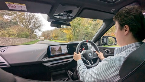 Ryan Gilmore drives the BMW 135M, black interior, over-shoulder shot