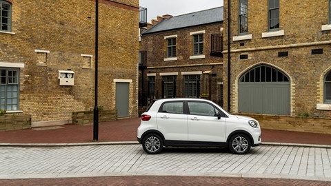 Leapmotor T03 (2025) review: side view static, buildings in background, white paint