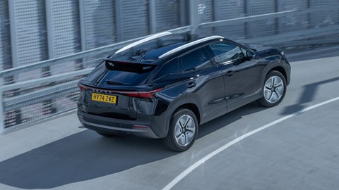 Omoda E5 review, rear, high, black, driving round corner