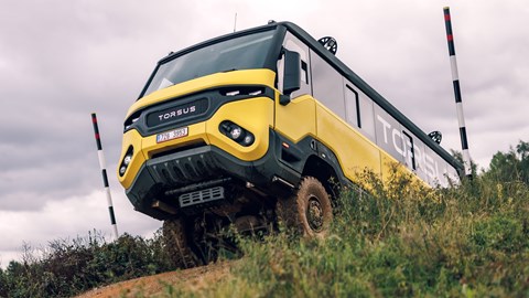 Torsus Praetorian review - front, yellow, cresting a hill at Millbrook Proving Ground