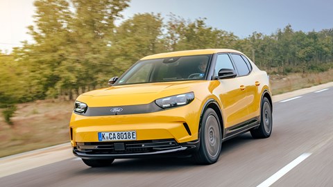 Ford Capri (2024) review: front three quarter driving, yellow paint, high angle