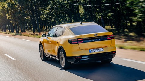 Ford Capri (2024) review: rear three quarter driving, yellow paint, high angle