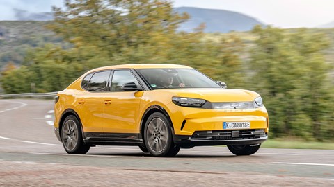 Ford Capri (2024) review: front three quarter cornering, yellow paint, high angle