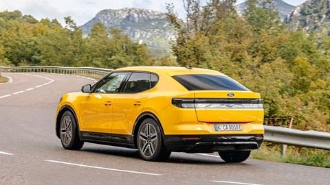 Ford Capri (2024) review: rear three quarter cornering, yellow paint, uphill