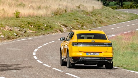 Ford Capri (2024) review: rear three quarter driving, yellow paint, twisty road