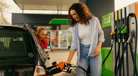 Woman fueling car - UK Budget 2024