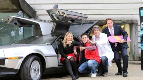 Queen's University graduates, staff and backers with the EV DeLorean. Photo: Paul McErlane