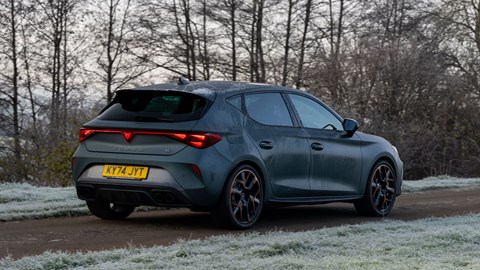 Cupra Leon (2024) review: rear three quarter driving, matte grey paint