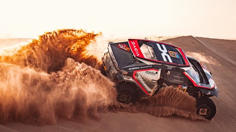 Image of a Dacia Sandrider Dakar Rally car surfing a sand dune