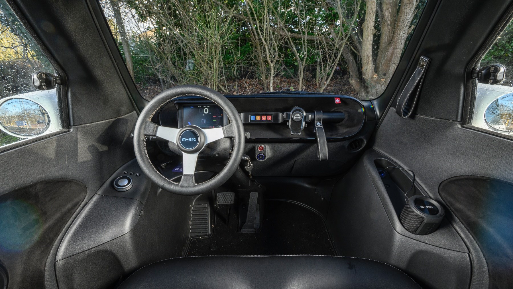 Interior view of Micro Microlino (2025) showcasing its sleek, minimalist dashboard and modern cabin design.