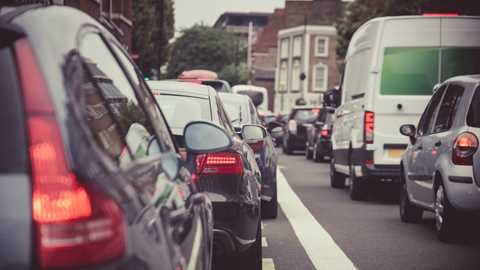 Image of two lines of stationary traffic on a British urban road