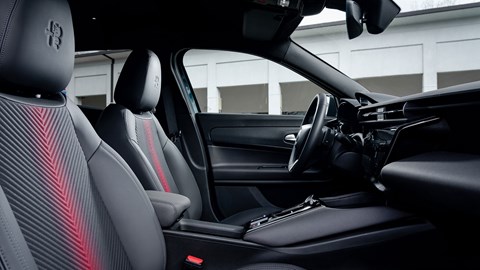 Alfa Romeo Junior Ibrida (2025) review: front seats and centre console, black upholstery