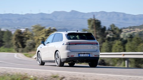 Leapmotor C10 REEV (2025) review: rear three quarter cornering, grey paint, mountain in background