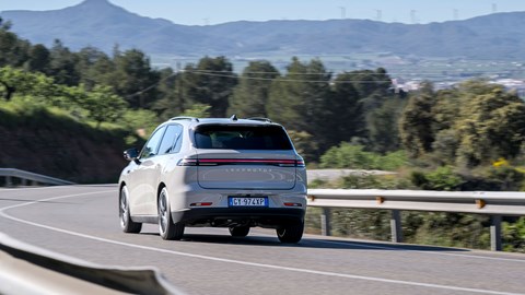 Leapmotor C10 REEV (2025) review: rear three quarter cornering, grey paint, mountain in background, wide shot