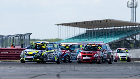 image of Graham King's Suzuki Swift race car between two others at Copse corner at Silverstone circuit