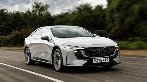 Mazda 6e (2026) review: front three quarter driving, grey paint, low angle