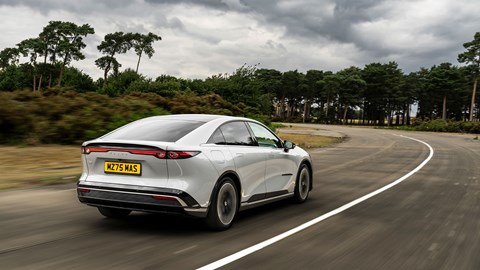 Mazda 6e (2026) review: rear three quarter driving, grey paint