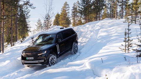 Range Rover Electric descending a steep, snowy hill
