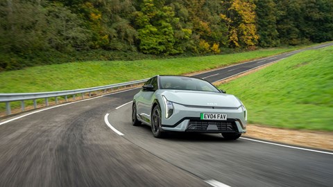 Kia EV4 Fastback (2025) review: front three quarter driving, green paint, low offset angle