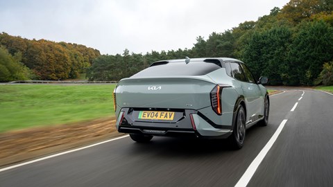 Kia EV4 Fastback (2025) review: rear three quarter driving, green paint, low angle