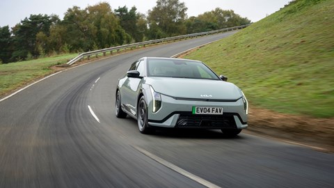 Kia EV4 Fastback (2025) review: front three quarter cornering, green paint, low angle