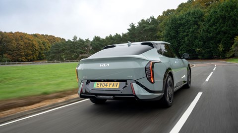 Kia EV4 Fastback (2025) review: rear three quarter driving, green paint, low angle