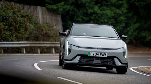 Kia EV4 Fastback (2025) review: front three quarter cornering, green paint, low angle