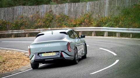 Kia EV4 Fastback (2025) review: rear three quarter cornering, green paint, body roll