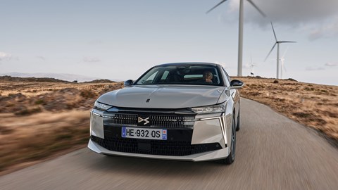 DS No.4 E-Tense (2025) review: front three quarter driving, silver paint, windfarm in background