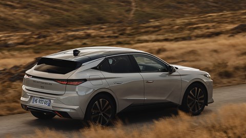 DS No.4 E-Tense (2025) review: rear three quarter driving, silver paint, grassland
