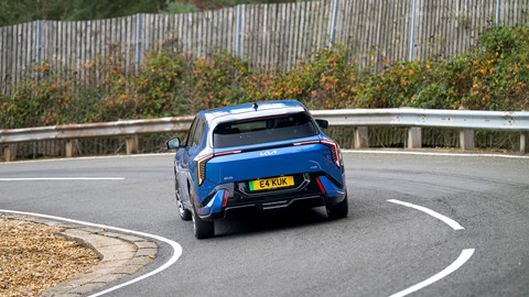 Kia EV4 (2025) review: rear three quarter cornering, blue paint, wide angle
