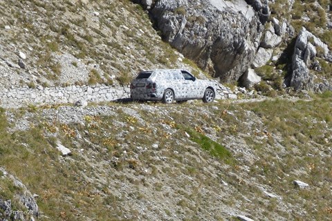 Rolls-Royce Cullinan negotiates a dusty track high in the Italian mountains