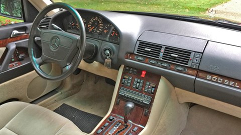 Inside the W140: 'glossy timber still adorns the cabin, and the wheel’s larger than what you’d expect to find on a yacht'