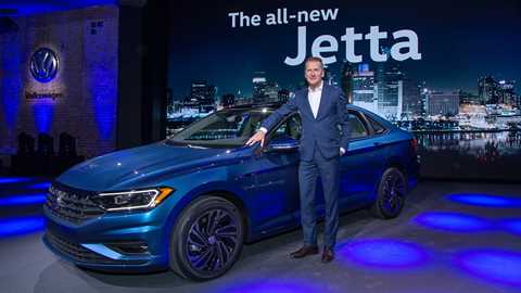 VW chief Dr Herbert Diess poses by the new 2018 Jetta in Detroit