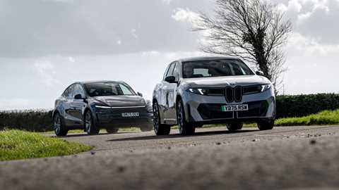 BMW iX3 and Tesla Model 3 on the road, front view