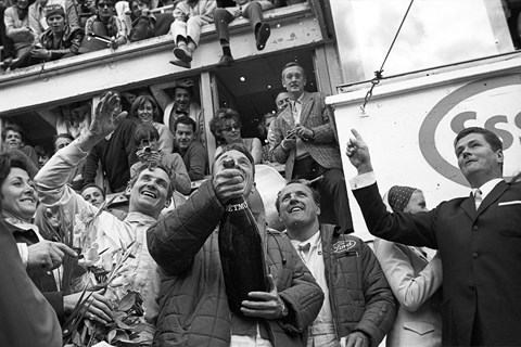 Dan Gurney, A J Foyt, Mike Parkes spray champagne at the 24 Hours of Le Mans, Le Mans, 11 June 1967 (Getty)