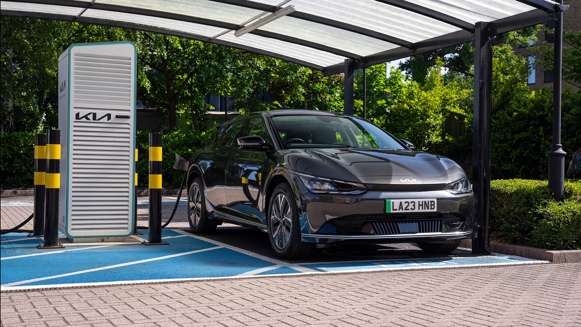 an electric car 2023 is parked at a charging station.