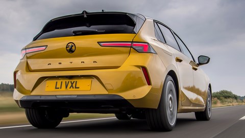 Vauxhall Astra PHEV rear three quarter driving, low angle, yellow car
