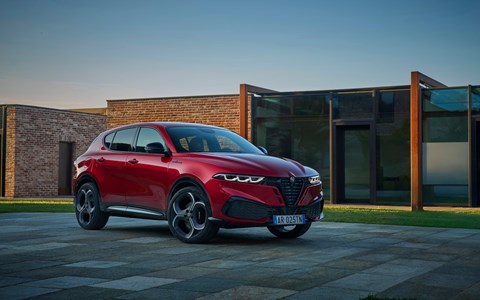 Image of a red Alfa Romeo Tonale, viewed from the front right corner
