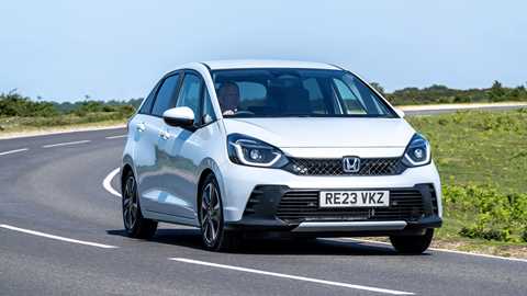 CAR magazine lists the cheapest hybrid cars on sale in the UK - white Honda Jazz, driving