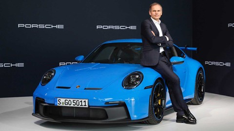 Oliver Blume poses by a Porsche 911 GT3