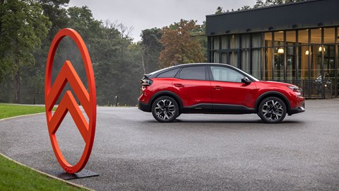 Citroen C4 facelift: side view static, red paint, Citroen badge in foreground