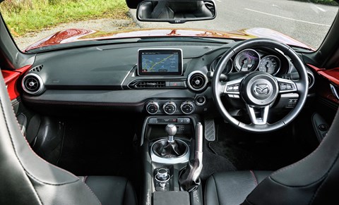 MX-5 interior gets red stitching for its black leather seats, the inside doors are painted red