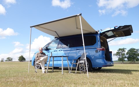 Image of a blue Volkswagen California pitched up in a field