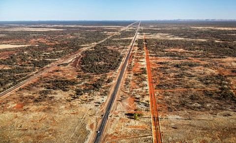 You can fly for hours across the Outback and from the opal sky you won’t see a single human mark on the red earth