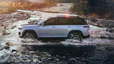 Jeep Grand Cherokee - UK pricing and spec revealed - white, side view, fording river, low sun, mountains