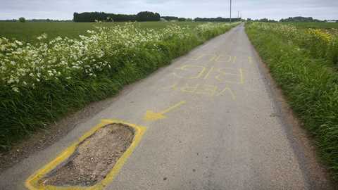 Claims for pothole damage are soaring on pockmarked UK roads (Getty)