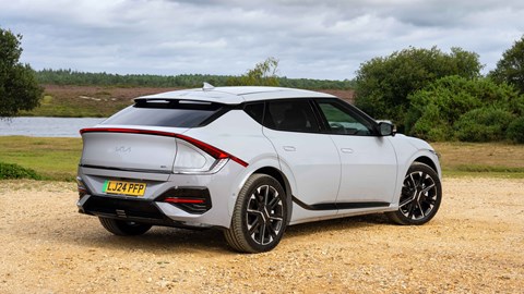 Kia EV6 facelift: rear three quarter static, grey paint, water in background