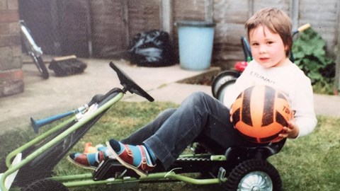 Once Keith outgrew his trike, four wheels proved better; football is a red - well, orange - herring